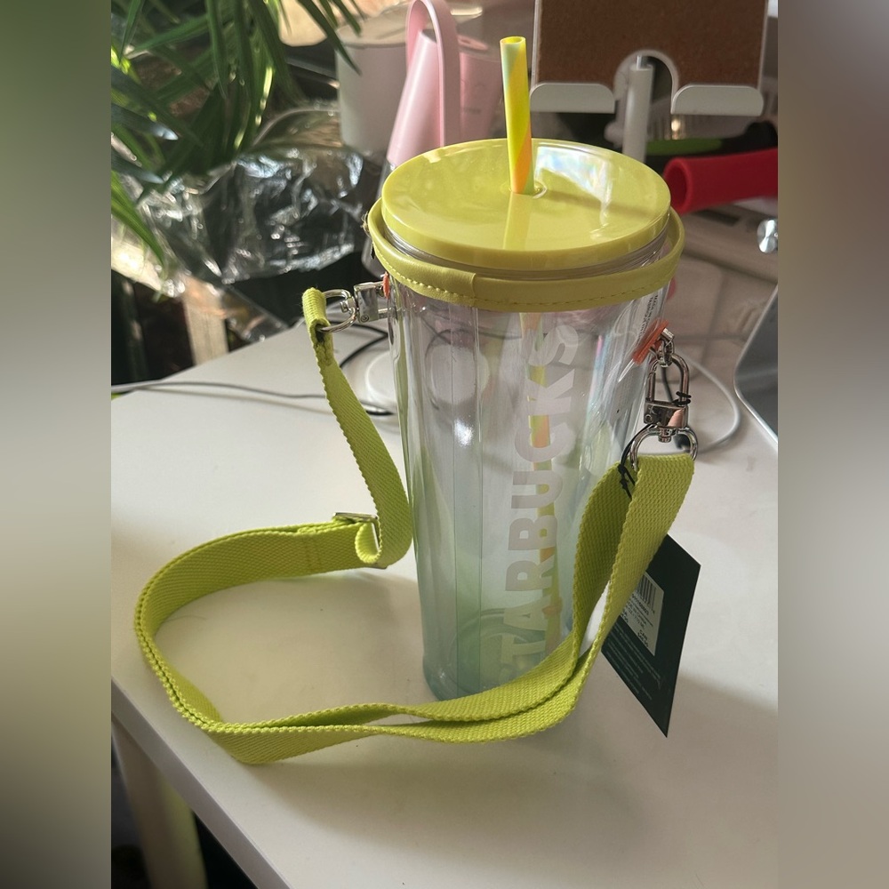 Starbucks Cold Cup and a carry case with yellow strap